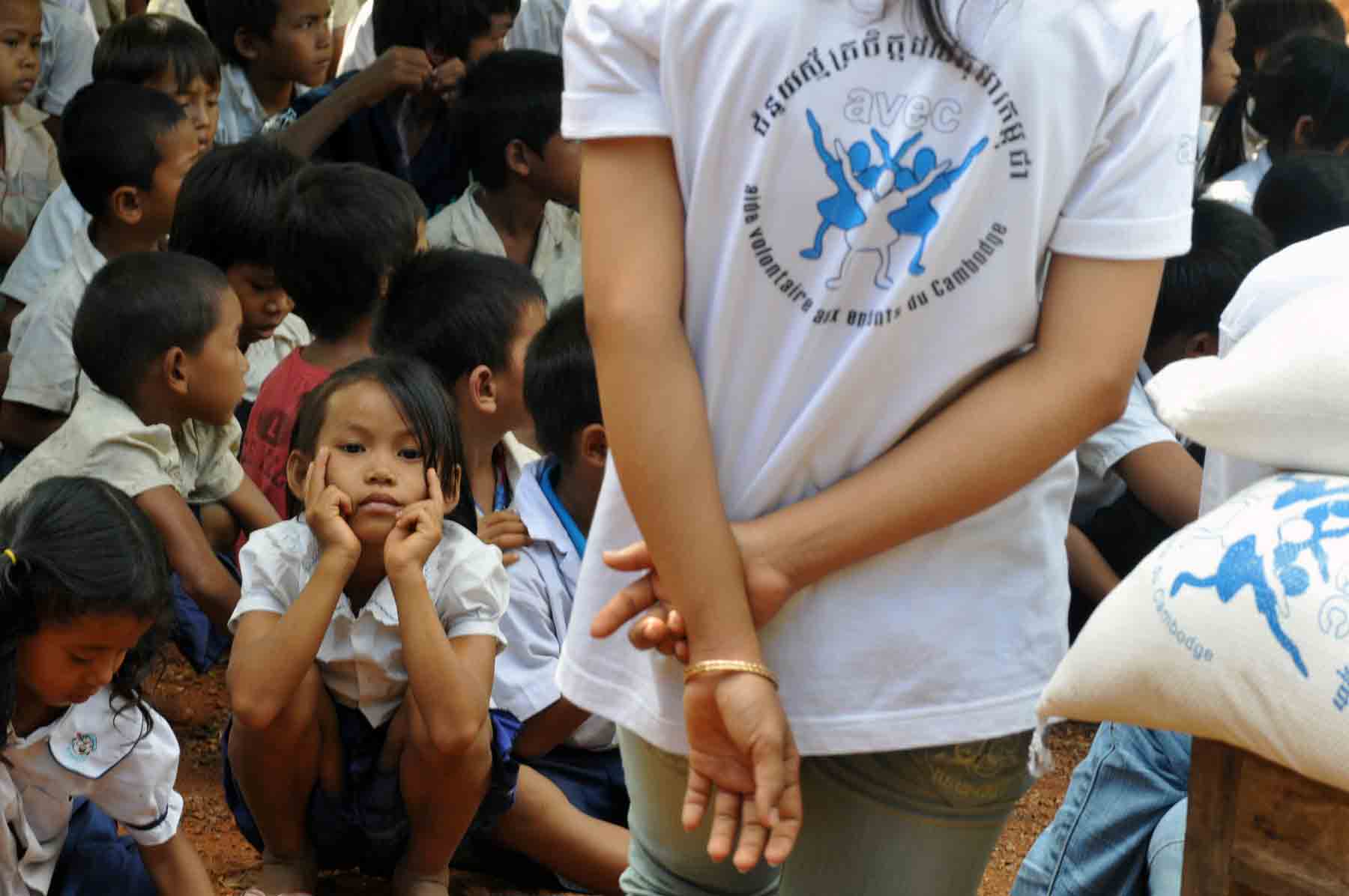 Young volunteer in Cambodia during an education-related humanitarian action with hundreds of children in a public school.