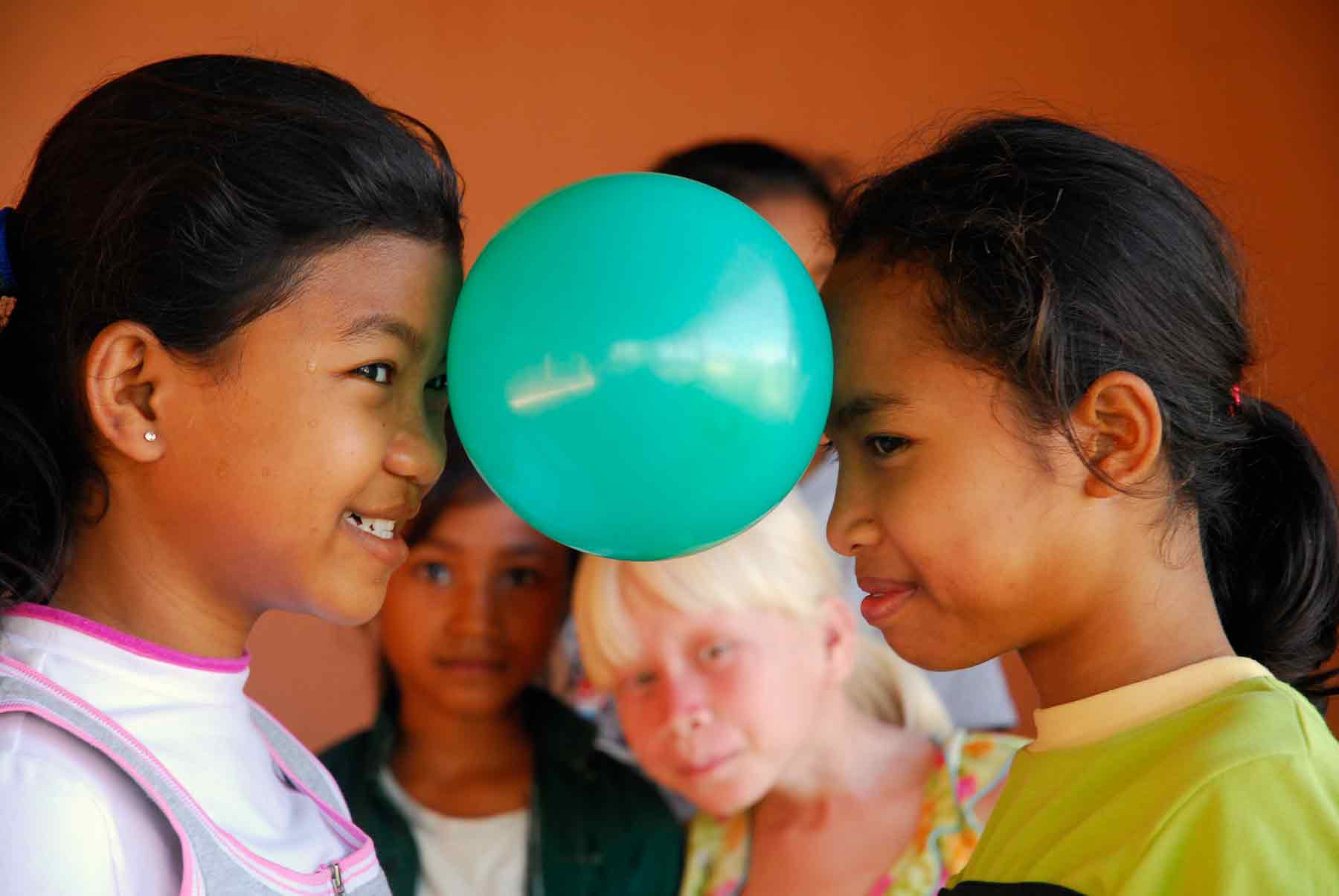 Two orphan girls play in our child protection center in Cambodia.