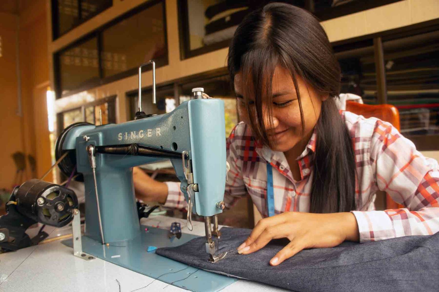 Young Cambodian girl following an apprenticeship in sewing design in a training center in Battambang, Cambodia.